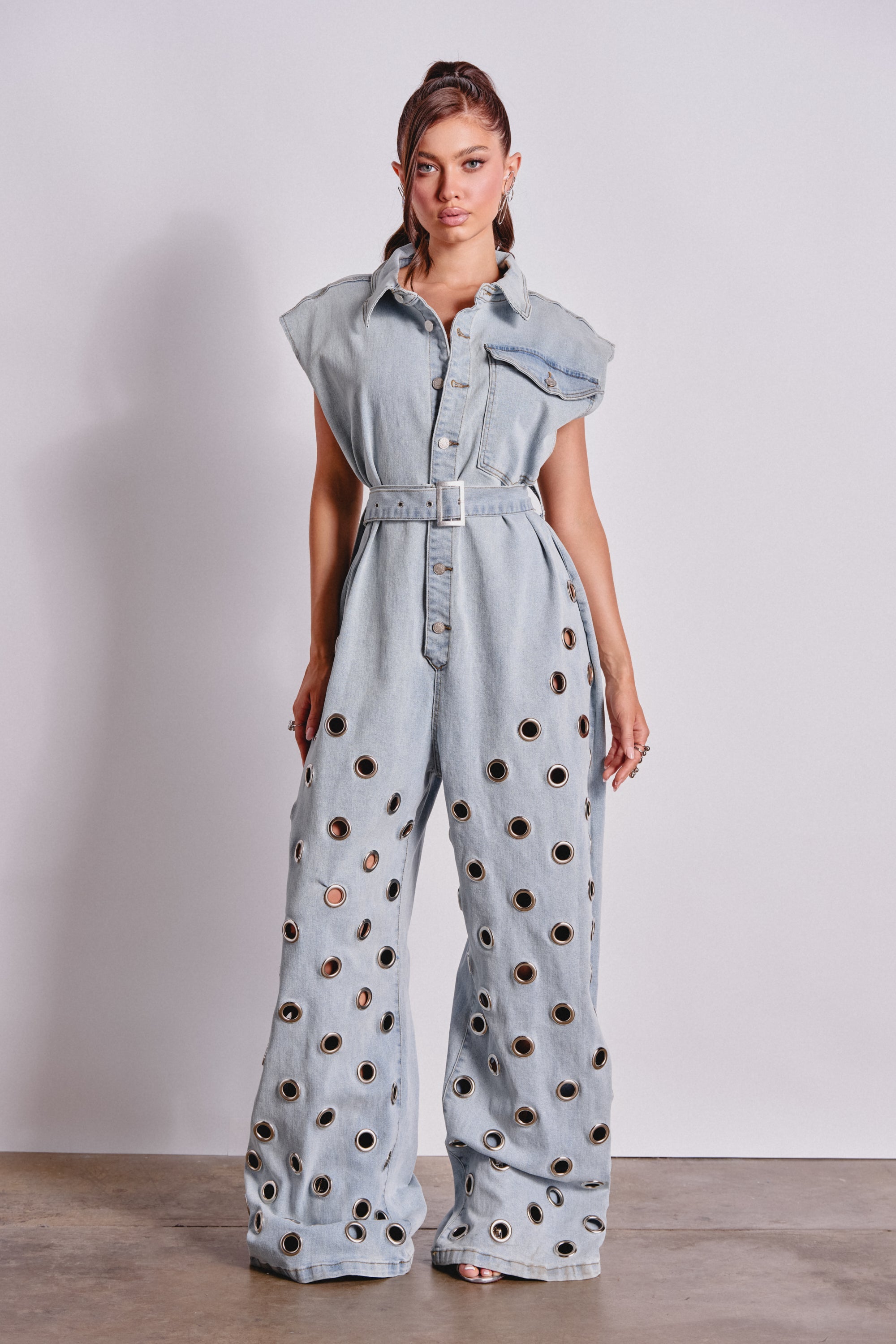 PLAY YOUR CARDS RIGHT DENIM JUMPSUIT WITH GROMMETS IN LIGHT WASH