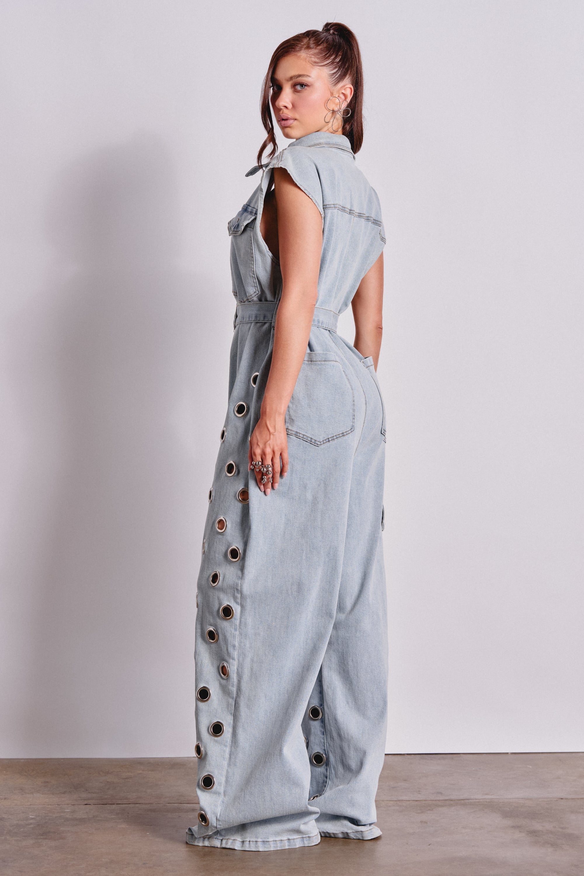 PLAY YOUR CARDS RIGHT DENIM JUMPSUIT WITH GROMMETS IN LIGHT WASH